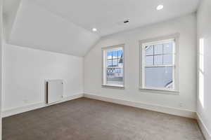 Additional living space featuring carpet flooring, vaulted ceiling, and recessed lighting