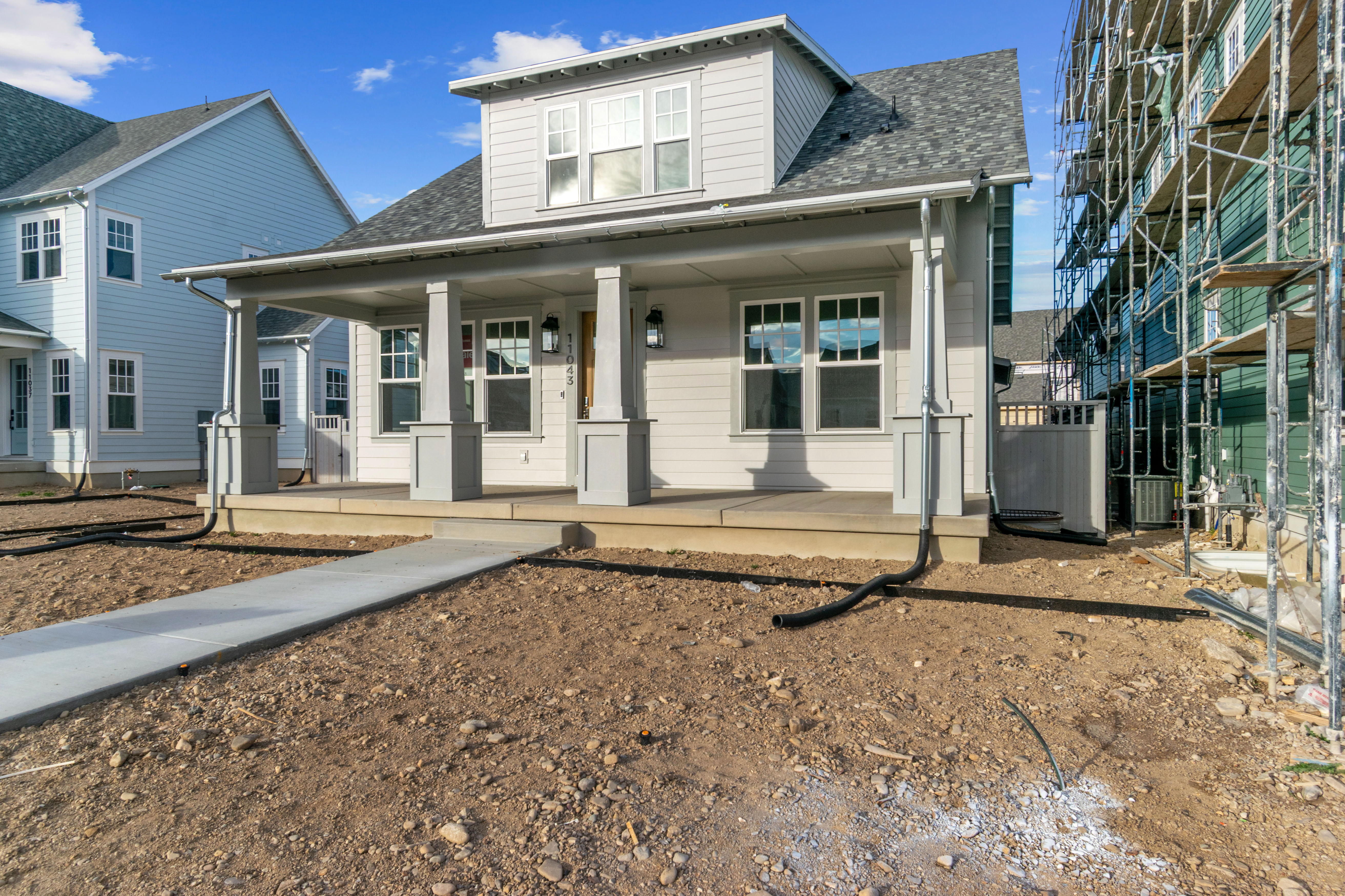 Bungalow-style home featuring roof with shingles and a porch