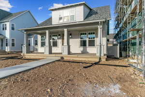 Bungalow-style home featuring roof with shingles and a porch