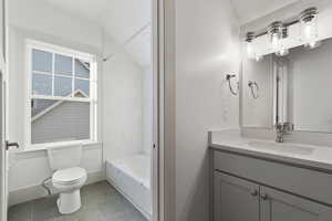 Bathroom with vanity and shower / washtub combination