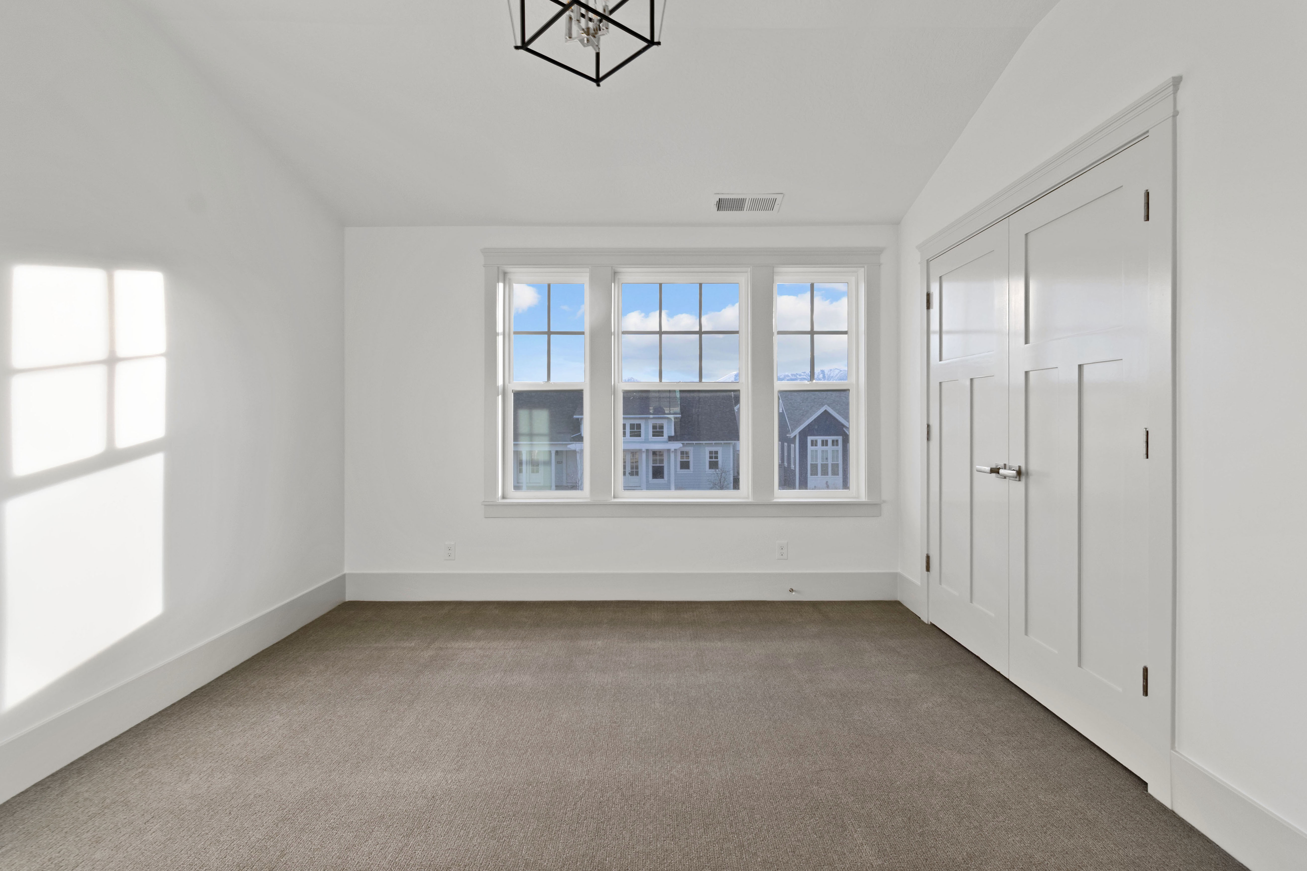 Unfurnished bedroom with lofted ceiling and dark colored carpet