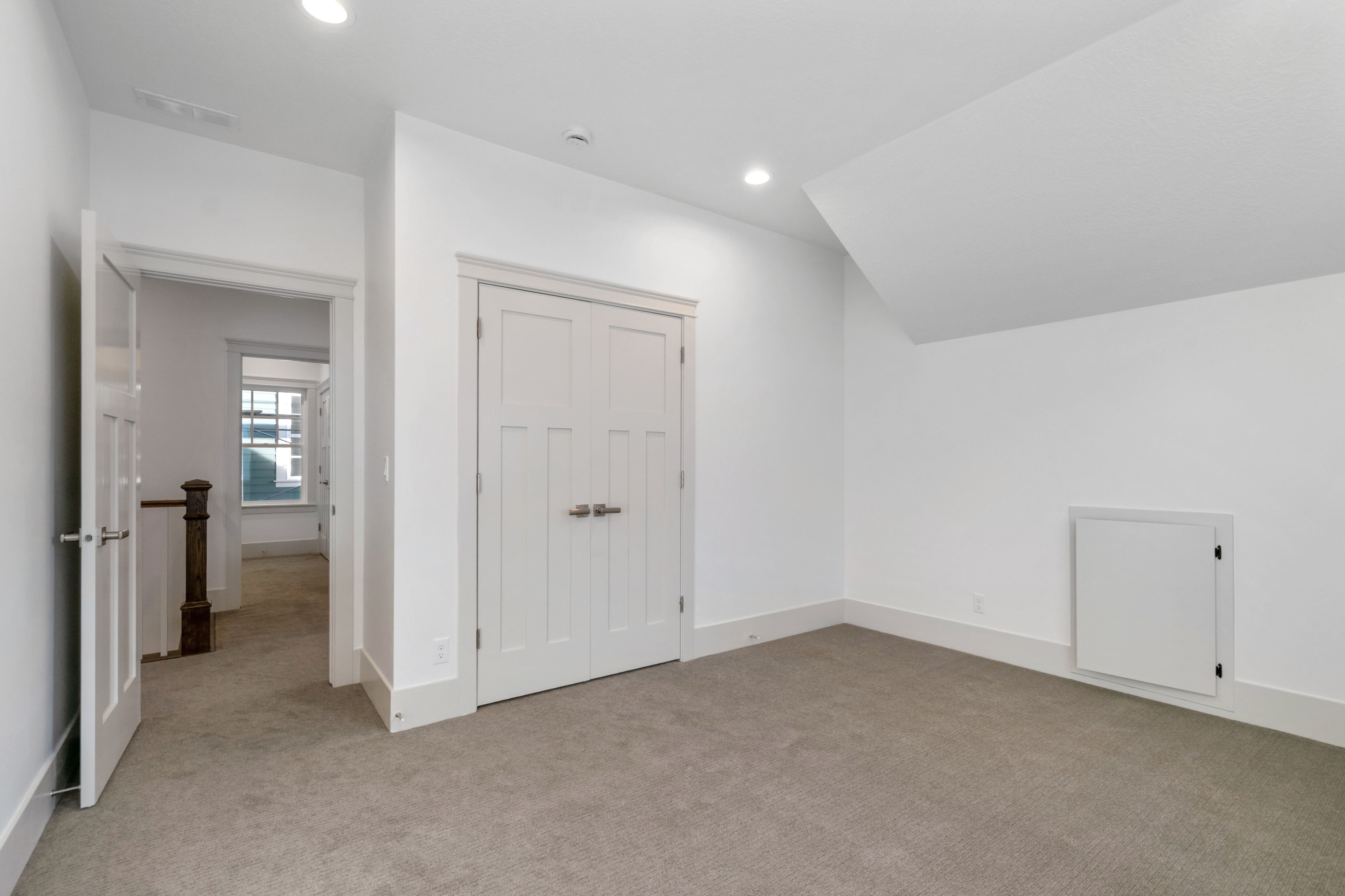 Additional living space featuring light carpet and recessed lighting