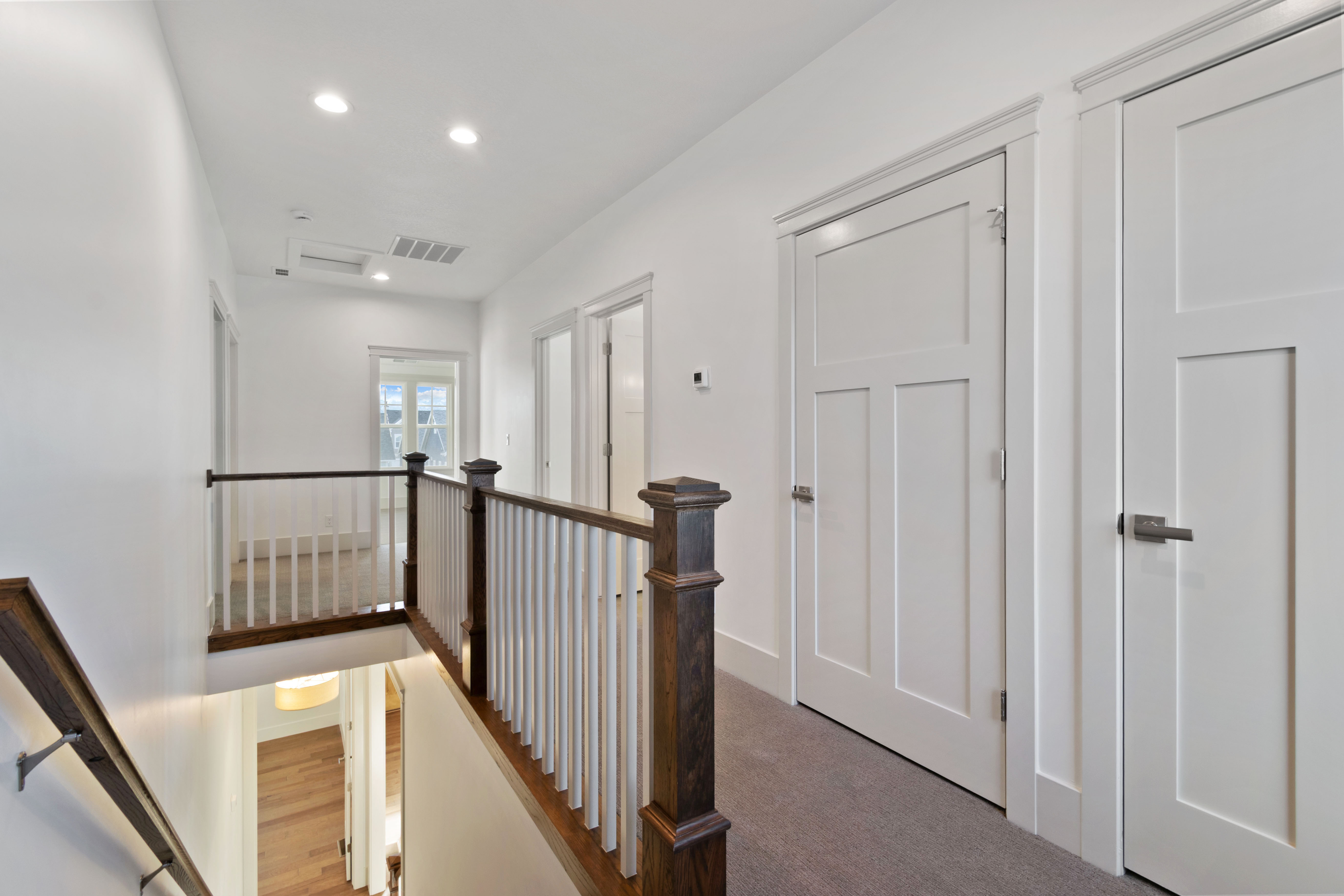 Hall featuring an upstairs landing and recessed lighting
