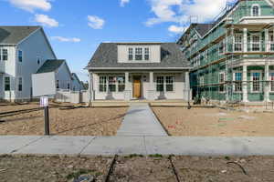 Bungalow-style home with roof with shingles and covered porch