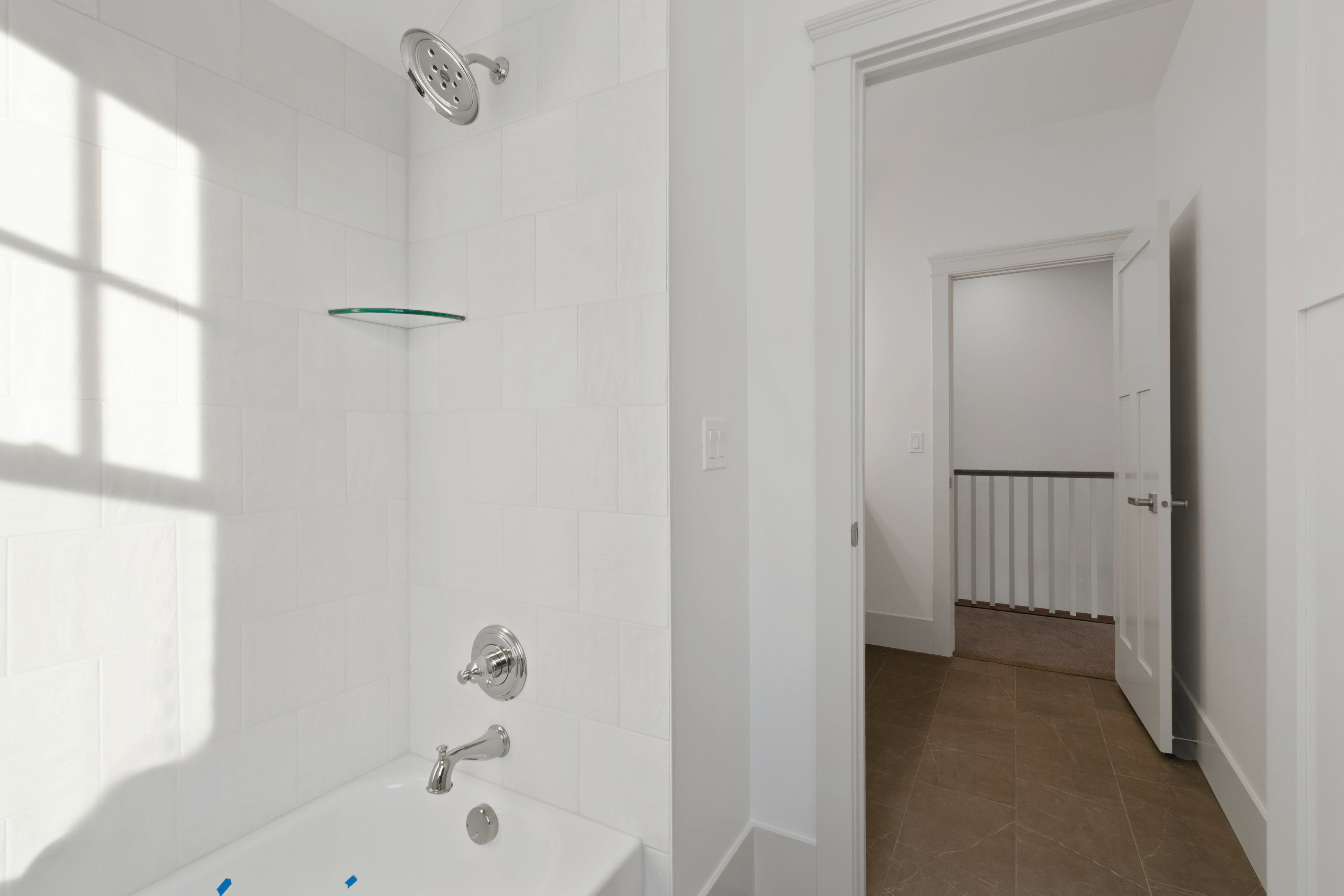 Full bath with washtub / shower combination and dark tile patterned flooring