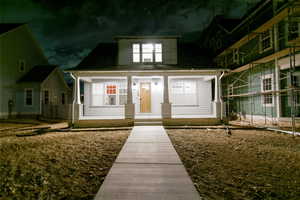Exterior entry at twilight featuring a porch