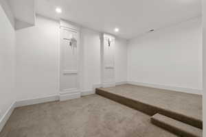Finished below grade area with carpet floors and recessed lighting