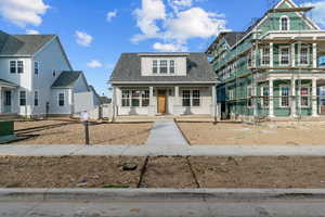 Bungalow-style house featuring a shingled roof and a porch