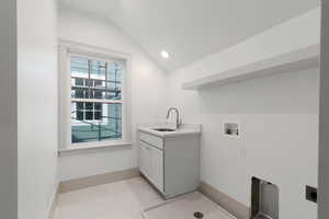 Laundry room with lofted ceiling, recessed lighting, hookup for a washing machine, and cabinet space