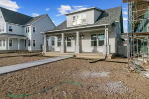 View of front of home with a porch and a shingled roof