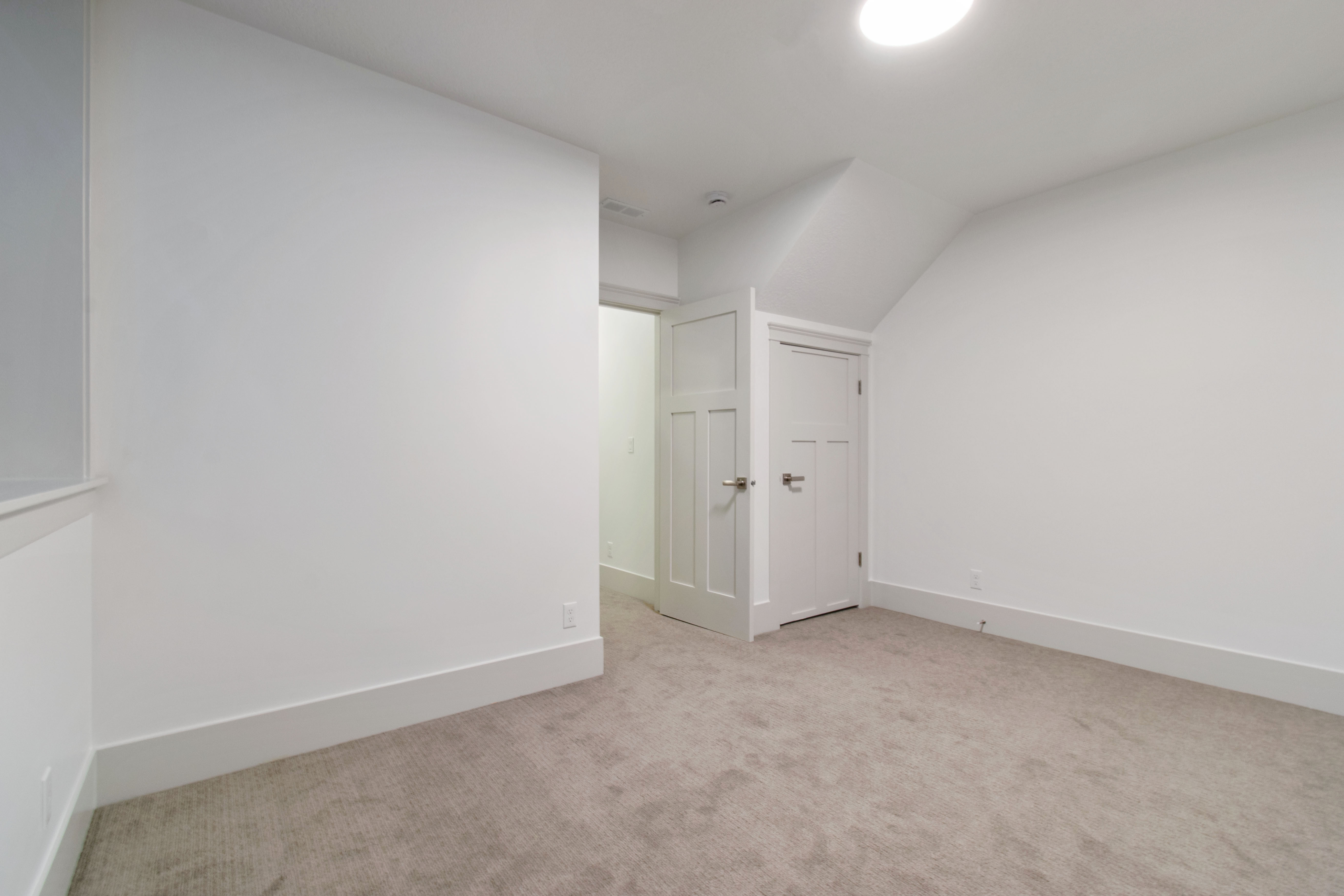Additional living space with carpet flooring and vaulted ceiling