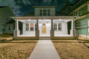 Exterior entry at twilight featuring covered porch