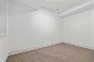 Unfurnished room featuring light colored carpet and baseboards