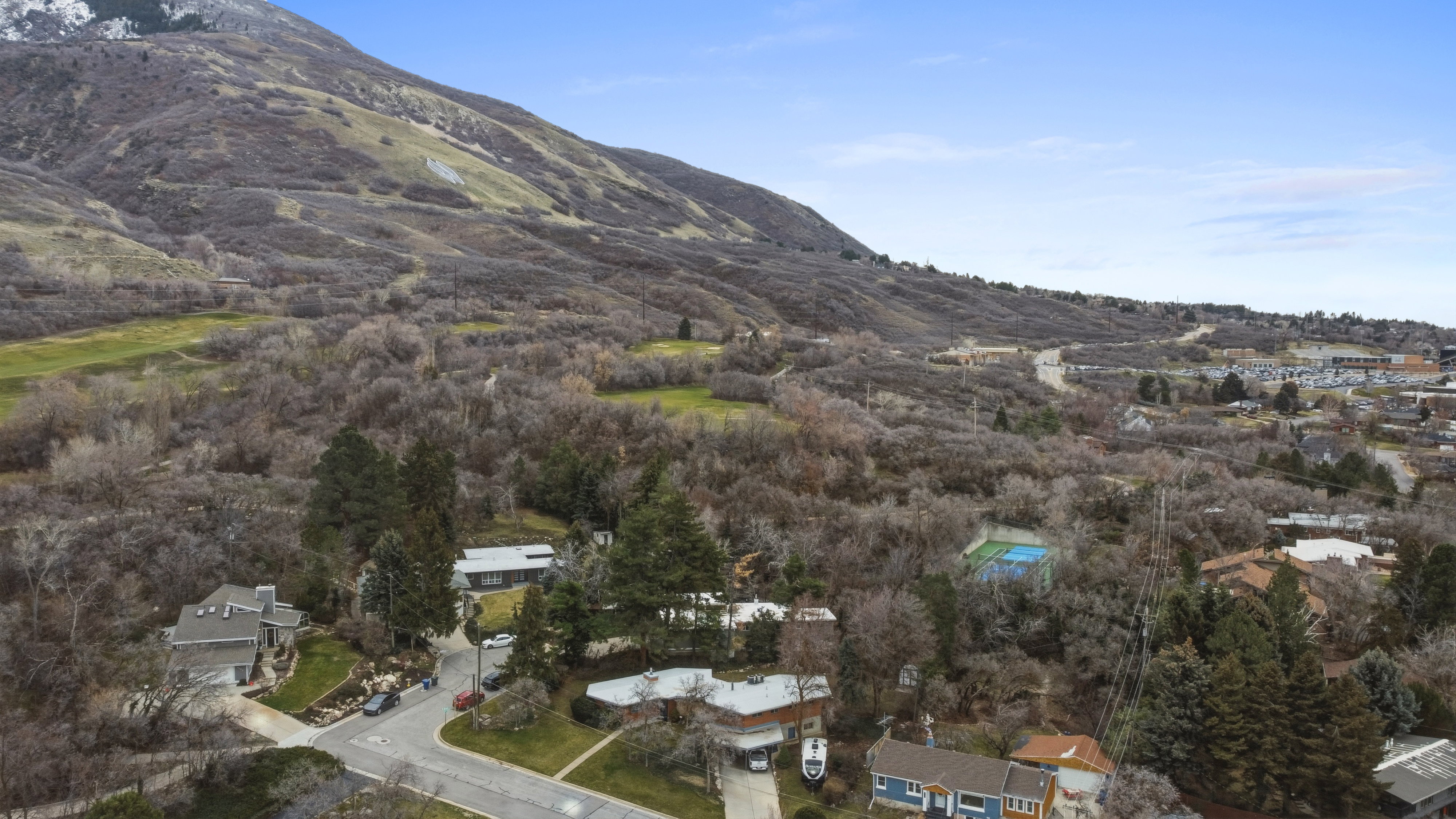 View of mountain backdrop featuring nearby suburban area