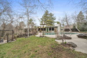 Rear view of property with a patio area and a fenced backyard