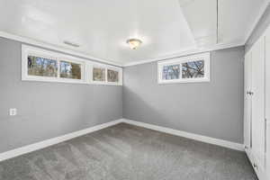 Carpeted empty room featuring baseboards