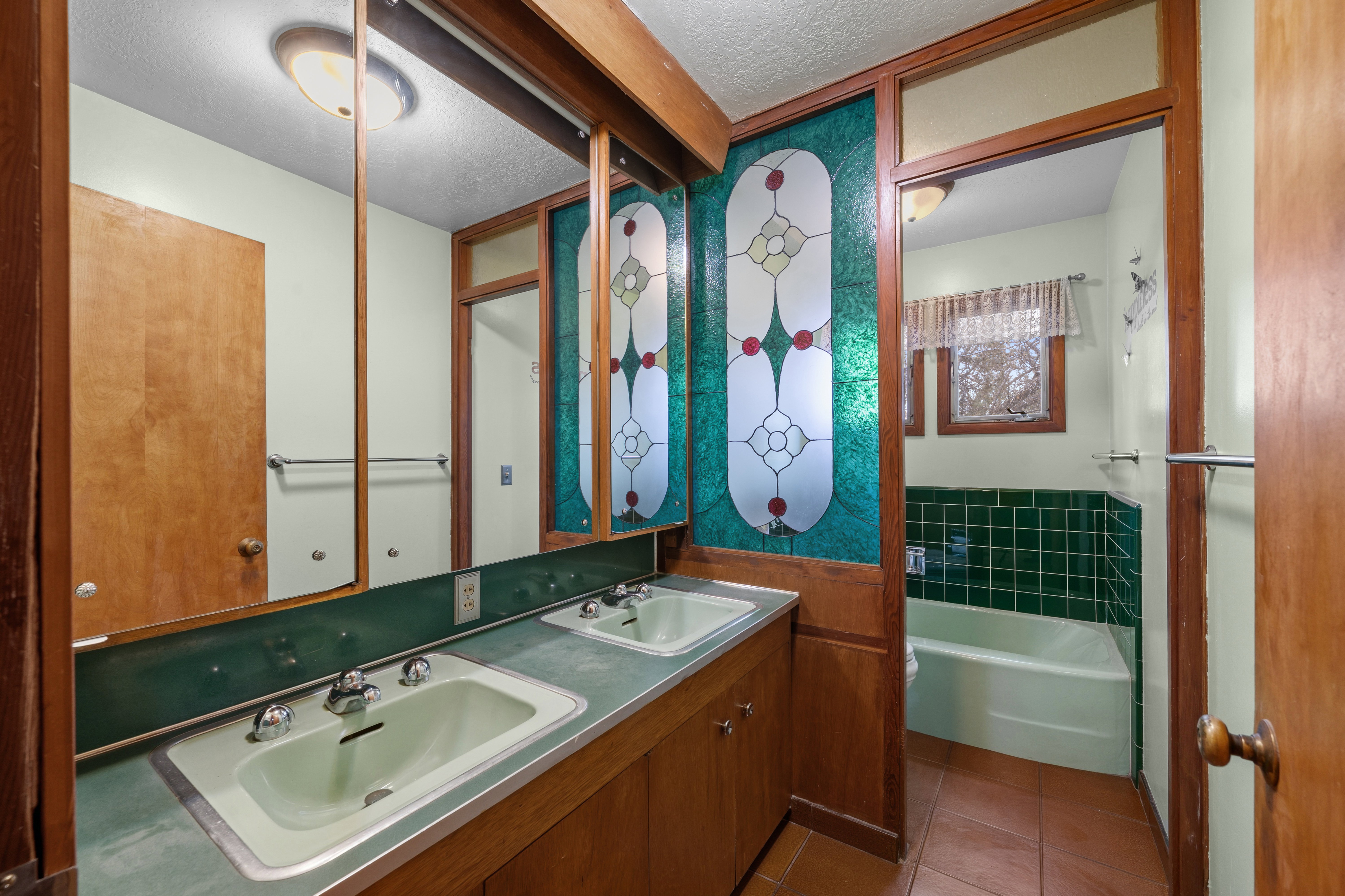 Bathroom with a bath, a textured ceiling, tile patterned flooring, and double vanity