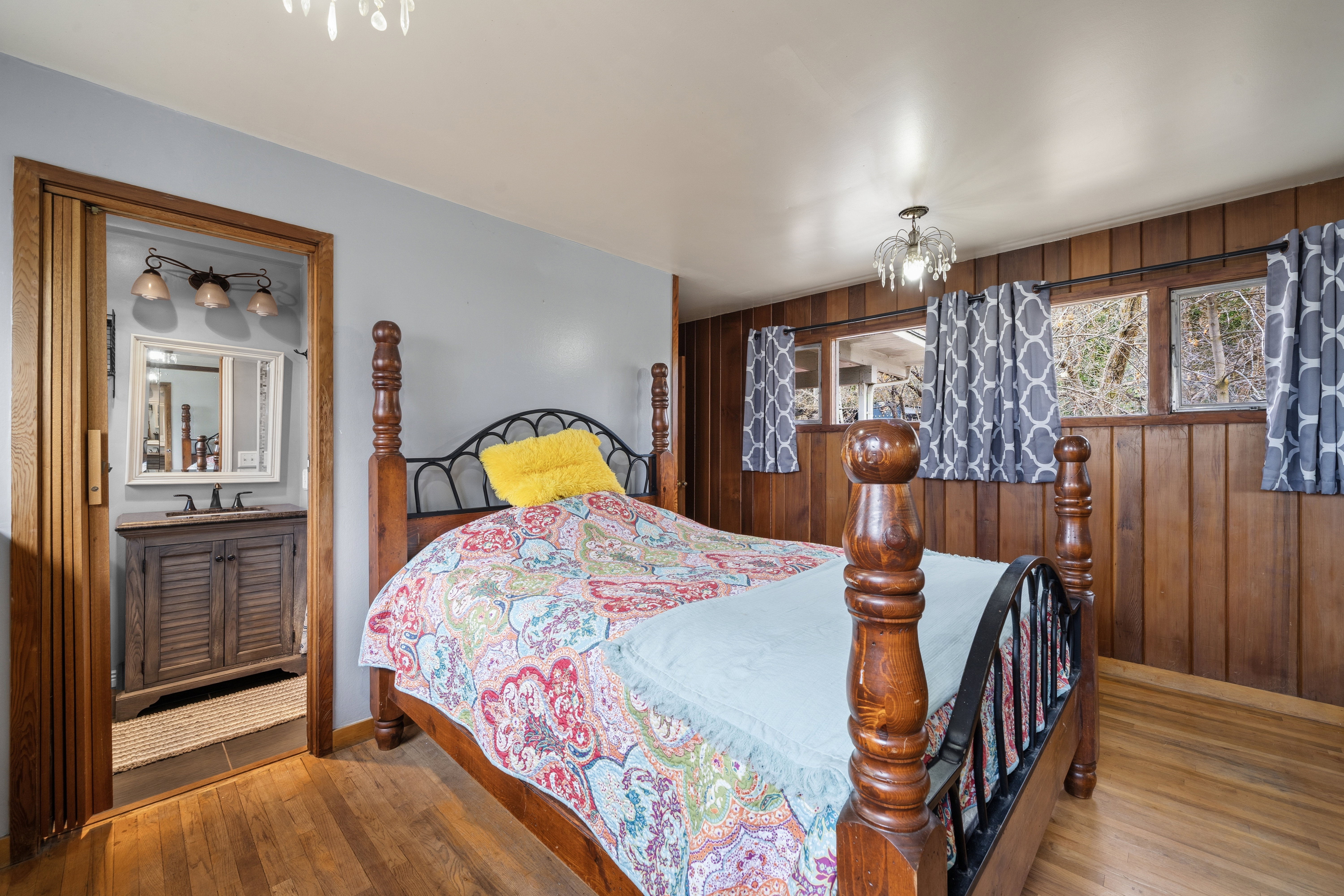 Bedroom with a chandelier, wood walls, and wood-type flooring
