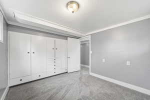 Unfurnished bedroom with light carpet and a textured ceiling