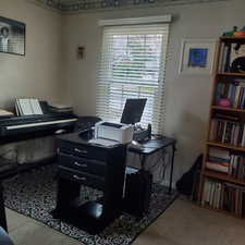 Home office with light colored carpet