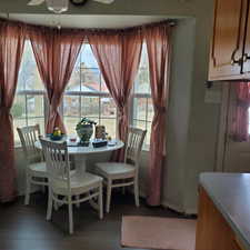 Dining space with dark wood-style flooring