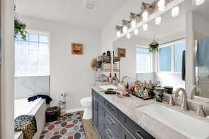 Full bathroom featuring a garden tub and double vanity