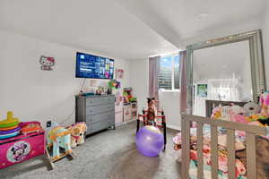 Carpeted bedroom featuring baseboards