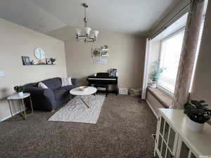 Living room with dark carpet and hanging lights