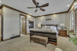 Carpeted bedroom featuring crown molding, recessed lighting, and ceiling fan