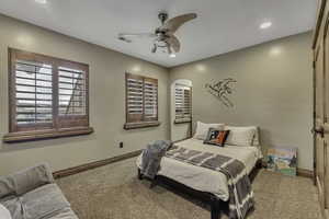 Carpeted bedroom featuring ceiling fan and recessed lighting