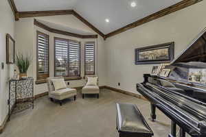 Living area with light carpet and crown molding