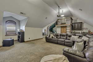 Home theater with light carpet and baseboards