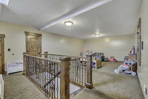 Game room with carpet and a textured ceiling