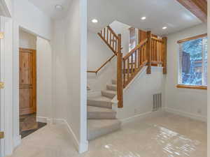 Stairs featuring carpet flooring and recessed lighting