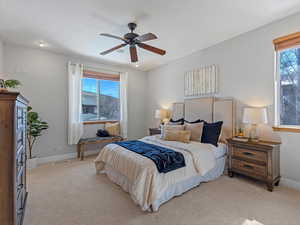 Bedroom with light colored carpet and ceiling fan