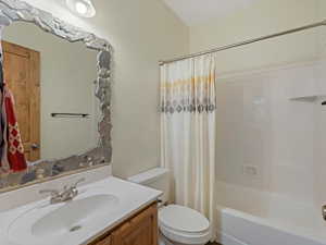 Full bathroom with vanity and shower / bathtub combination with curtain