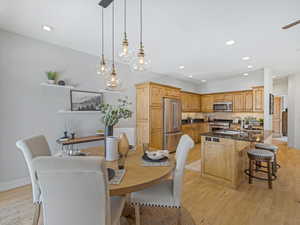 Dining space with light wood-type flooring and recessed lighting
