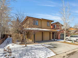 View of front of home with an attached garage and concrete driveway