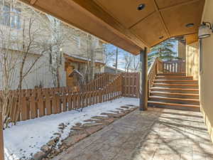 Snow covered patio featuring a patio area