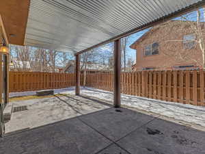 Fenced backyard with a patio