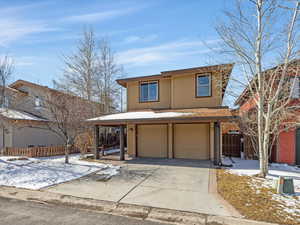 View of front of home with an attached garage and driveway