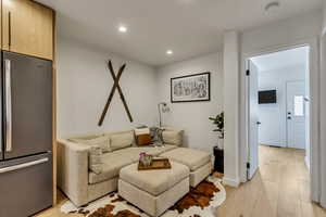 Living room with light wood-style floors and recessed lighting