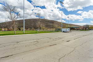 View of asphalt street featuring a mountain view and curbs