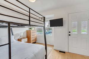 Bedroom with baseboards and light wood-style floors