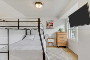 Bedroom featuring baseboards and light wood finished floors