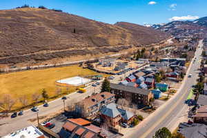 Aerial view of property and surrounding area with a mountainous background