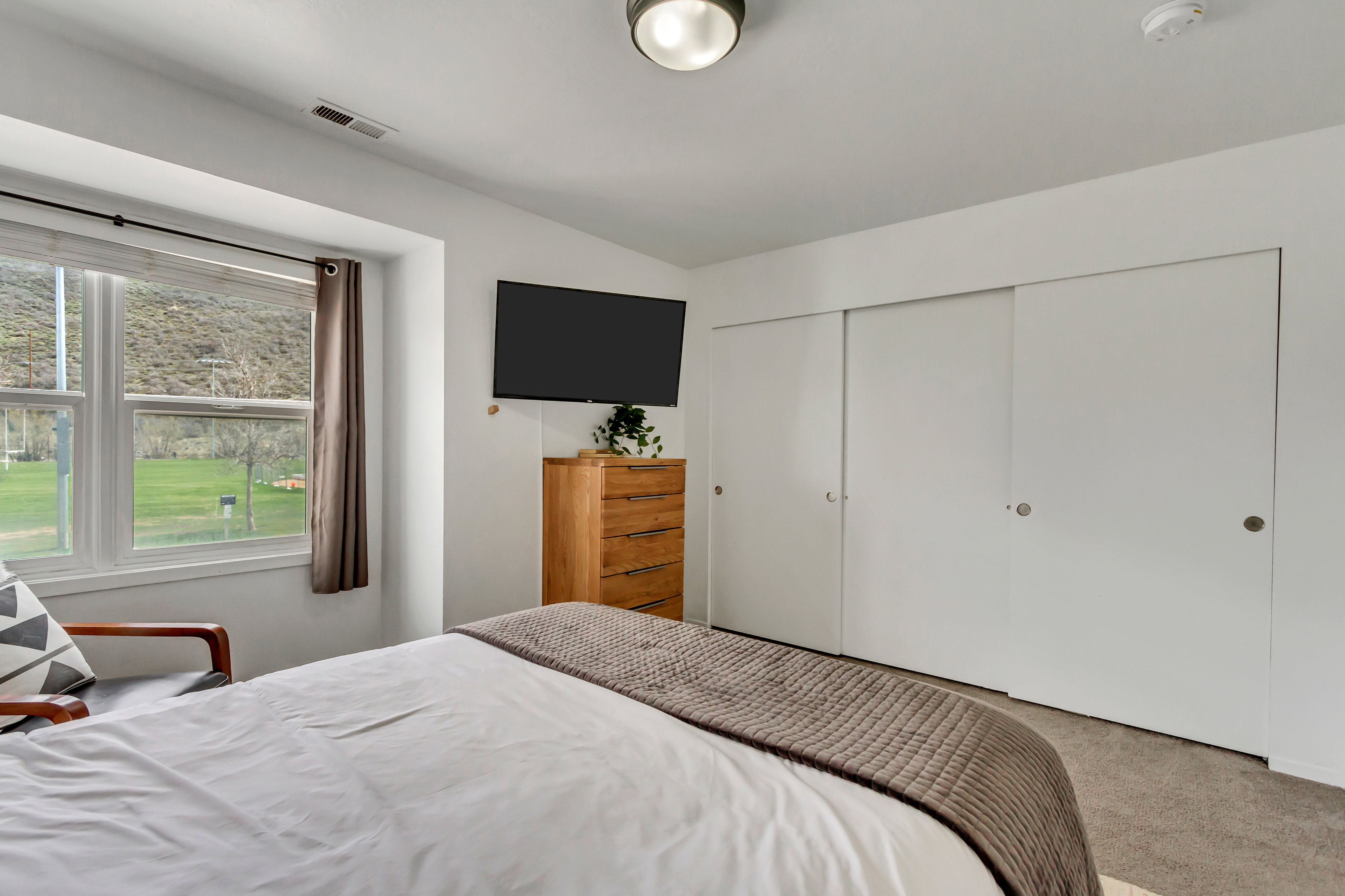 Carpeted bedroom featuring a closet