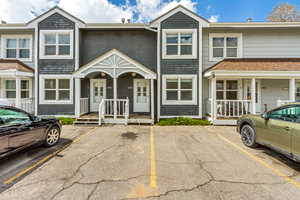 View of front of home featuring uncovered parking and a porch