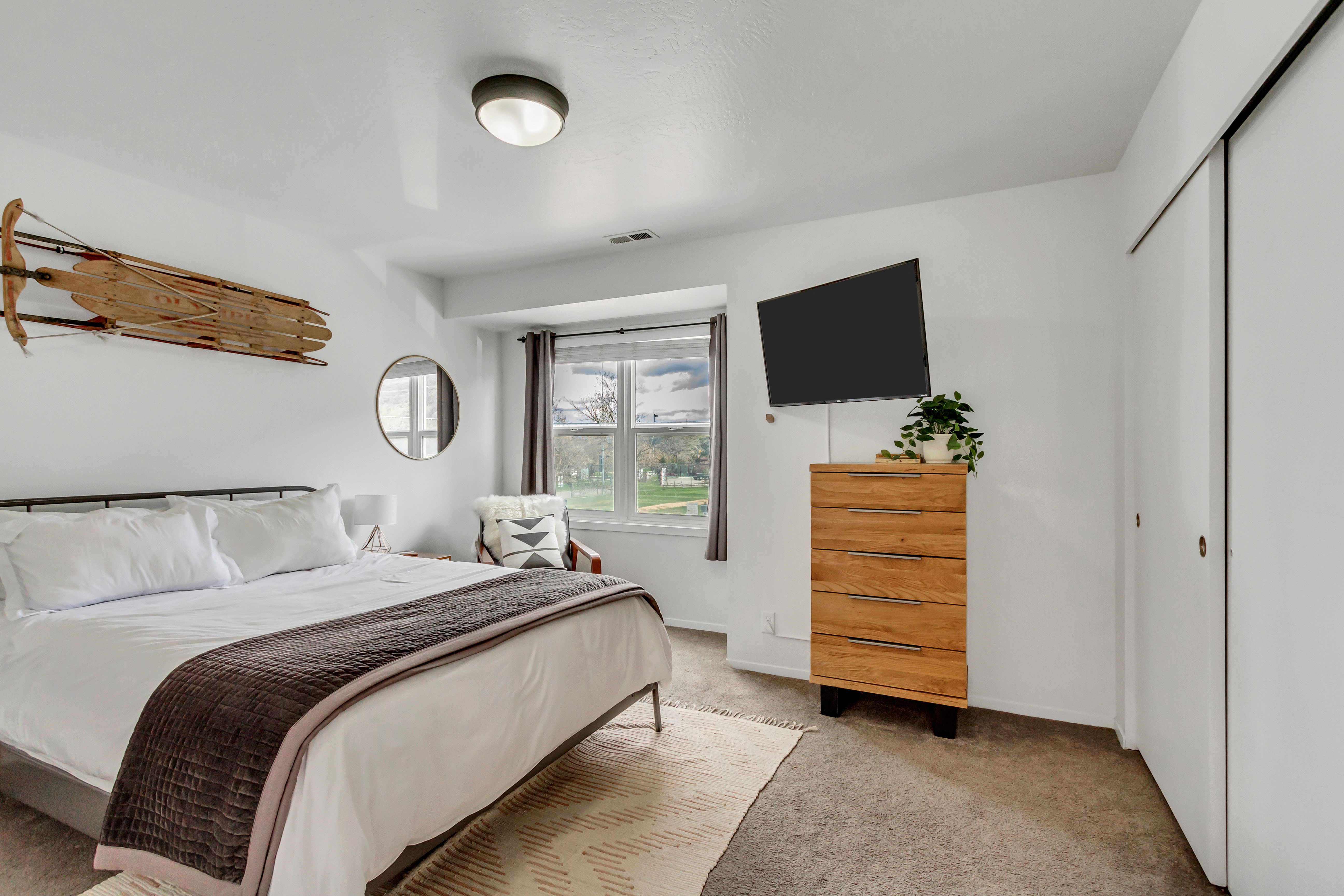 Bedroom featuring light colored carpet and a closet