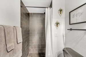Full bathroom featuring a shower stall